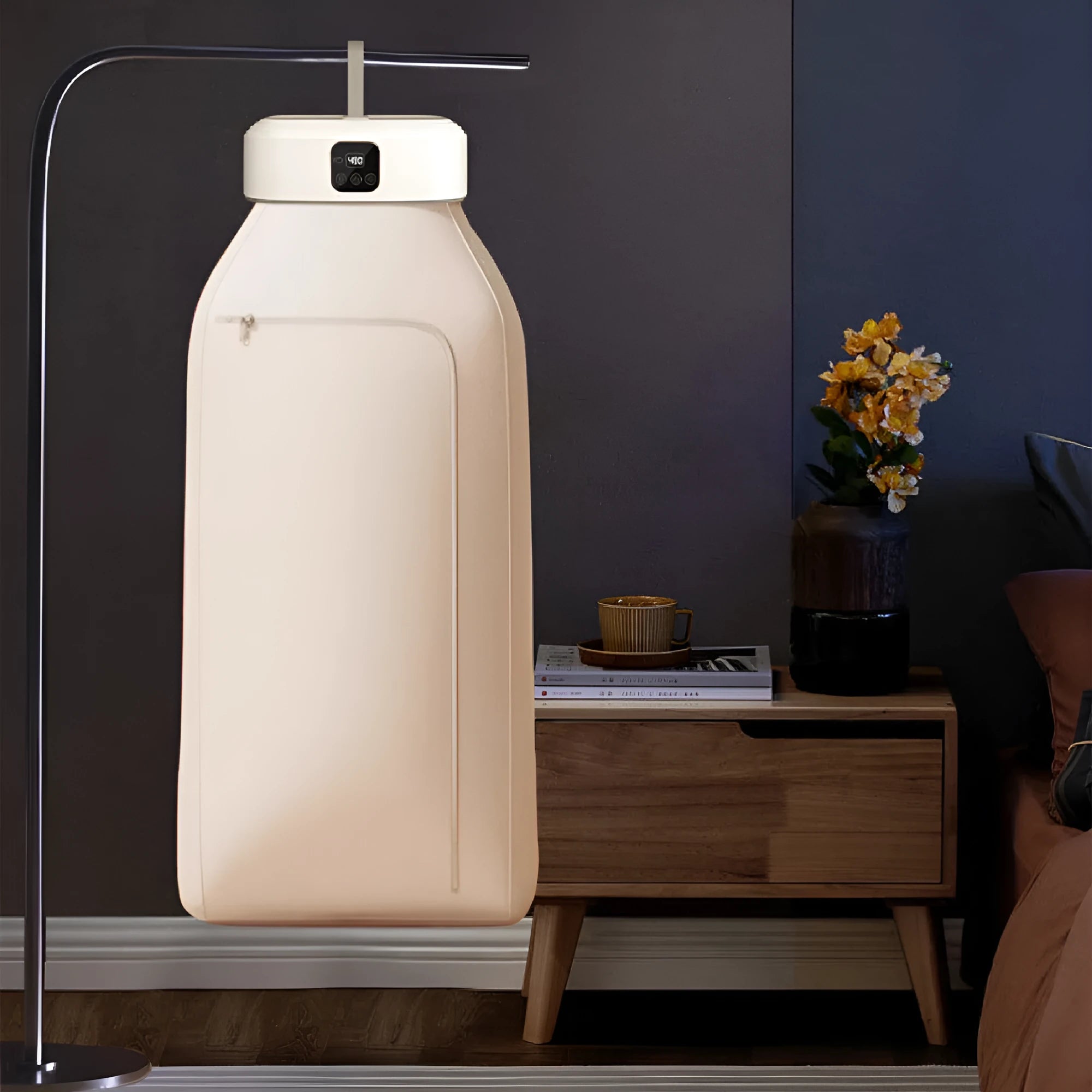 White cylindrical foldable laundry dryer with remote control for dormitory and small space use.