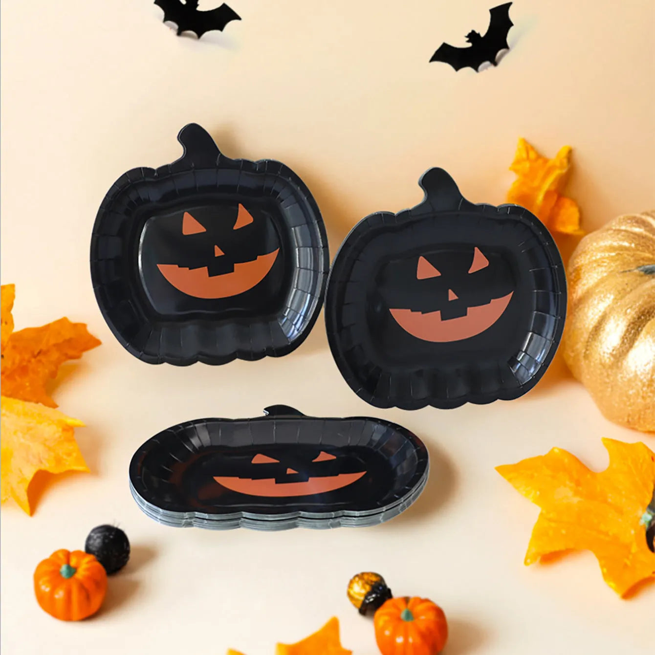 Black Halloween paper plates with pumpkin design measuring 9 inches diameter