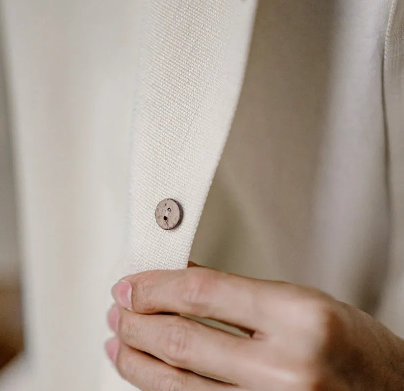 Light apricot men's shirt with bamboo and flower pattern, Cuban collar, on a hanger.