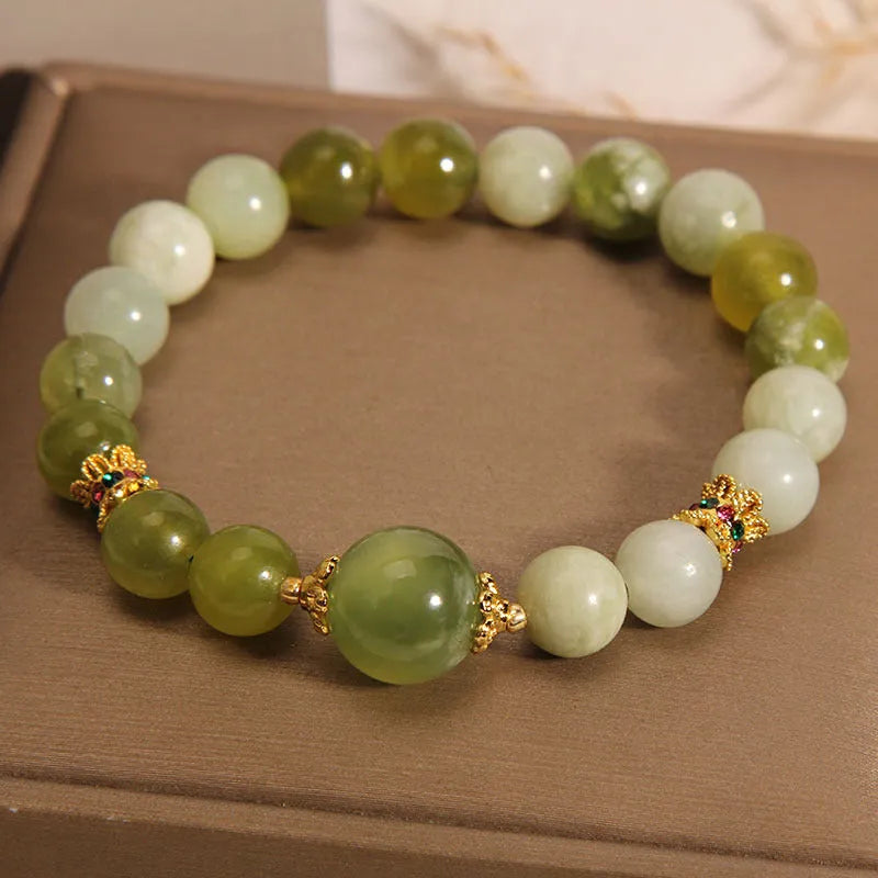 Women's solid Xiuyan jade bracelet in a green colour, shown as a single smooth bead.