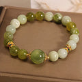 Women's solid Xiuyan jade bracelet in a green colour, shown as a single smooth bead.