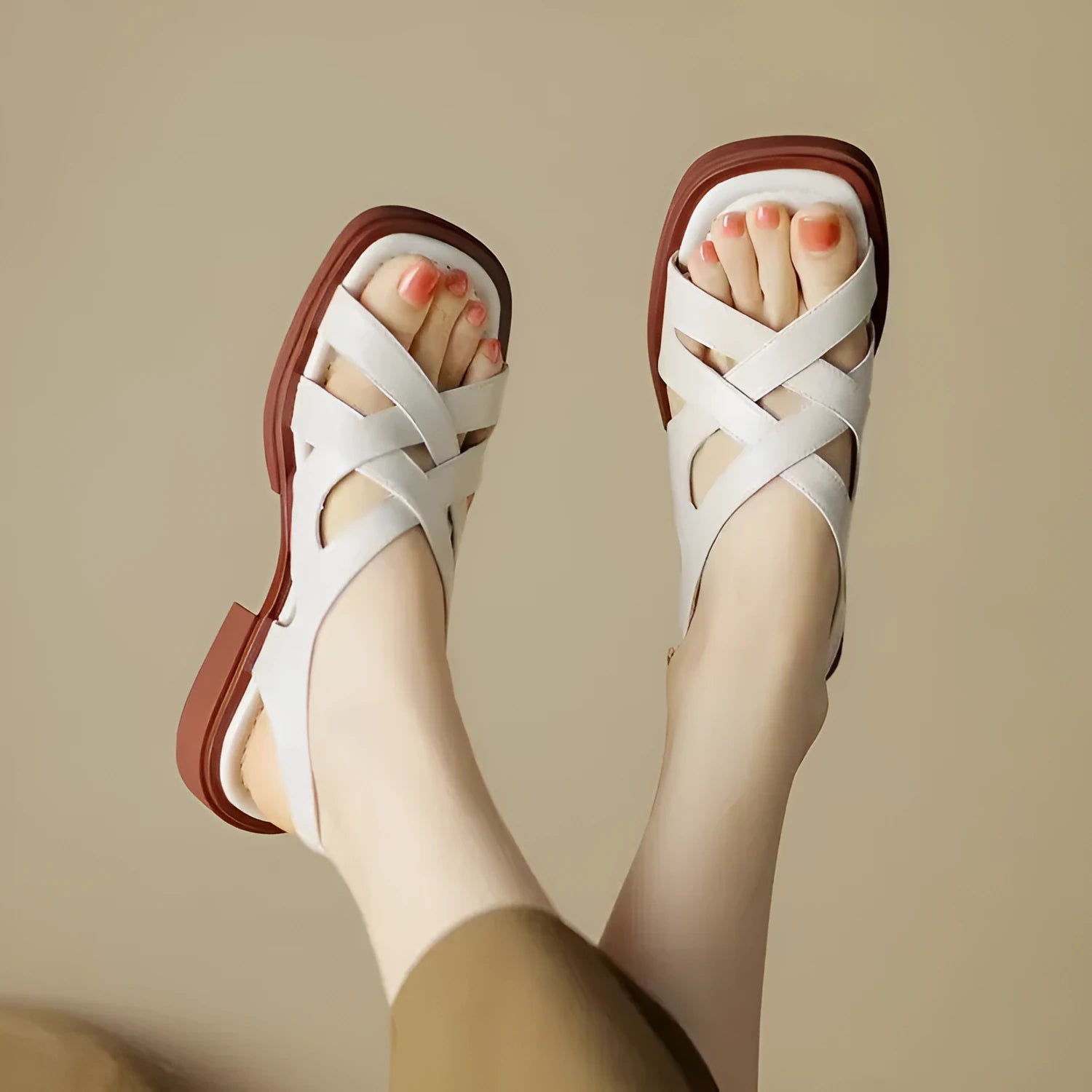Women's black patent leather square toe beach sandals with cross strap design on a white background