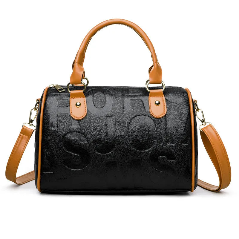 Brown cylindrical crossbody bag with three straps on a plain background