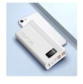 Black and white large capacity portable power bank with fast charging, showing size scale.