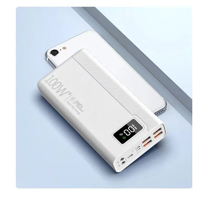 Black and white large capacity portable power bank with fast charging, showing size scale.