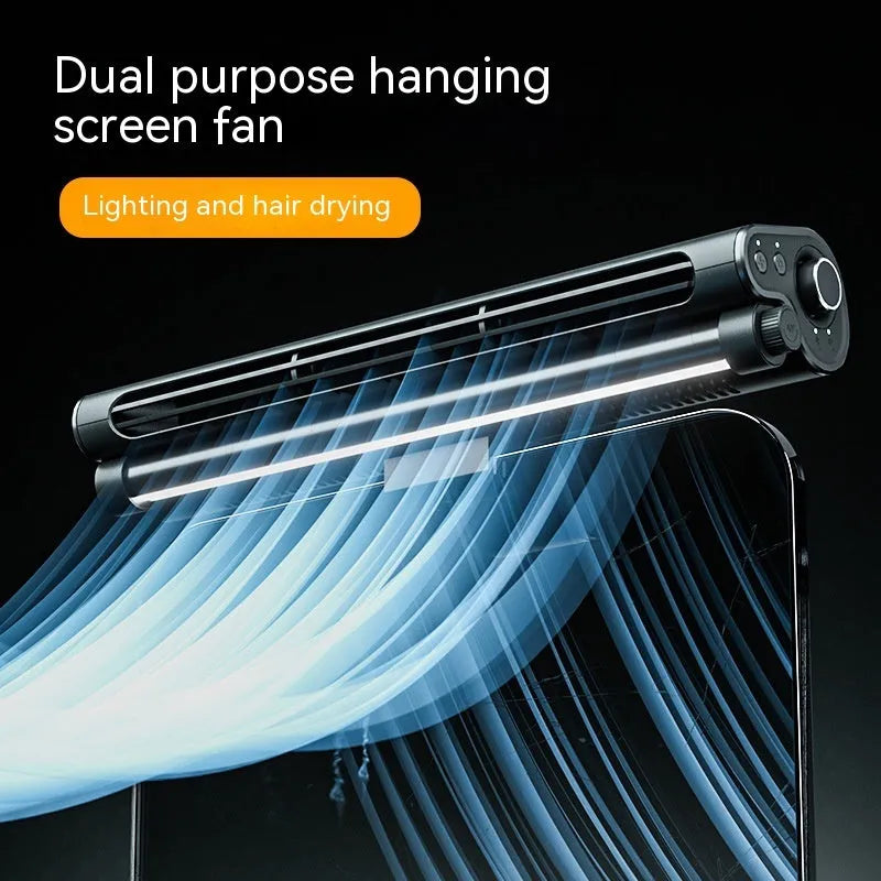 Black clip-on bladeless fan with integrated light attached to a laptop screen.