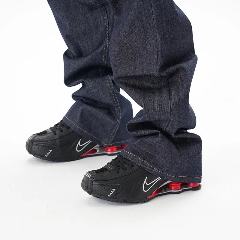 A pair of dark blue casual loose straight-cut jeans on a plain background.