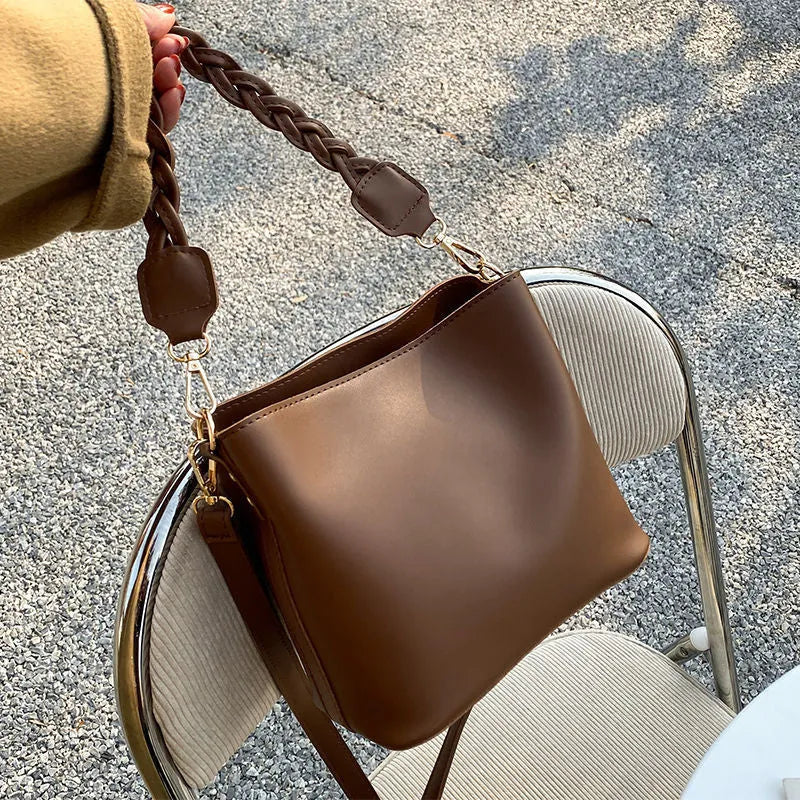 Khaki unisex PU crossbody bucket bag with woven texture and shoulder strap