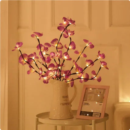 Pink LED phalaenopsis orchid branch decorative light on a table