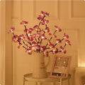 Pink LED phalaenopsis orchid branch decorative light on a table