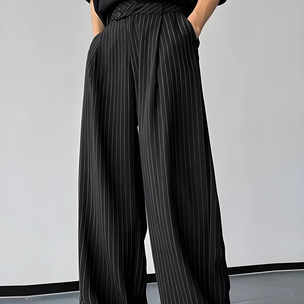 Men's black vertical striped pleated casual trousers showing elasticated waist and leg detail