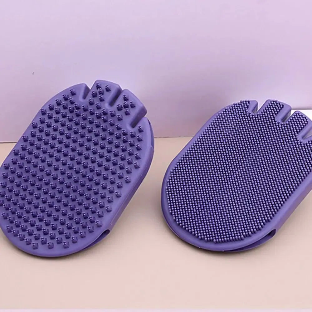 Purple dual-sided pet shampoo and massage brush with soft TPR bristles and ergonomic handle.