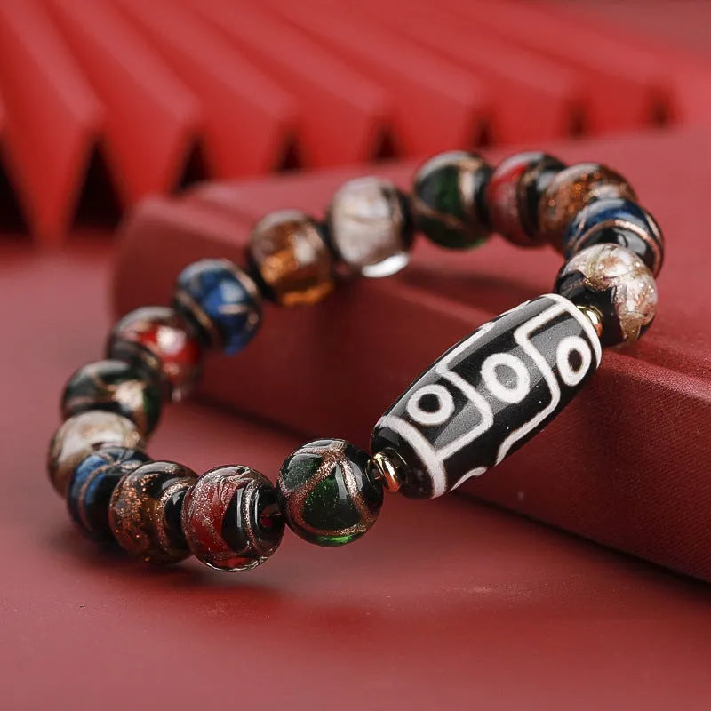 Chinese-style bracelet with coloured glaze beads showing snake and multi-treasure patterns.