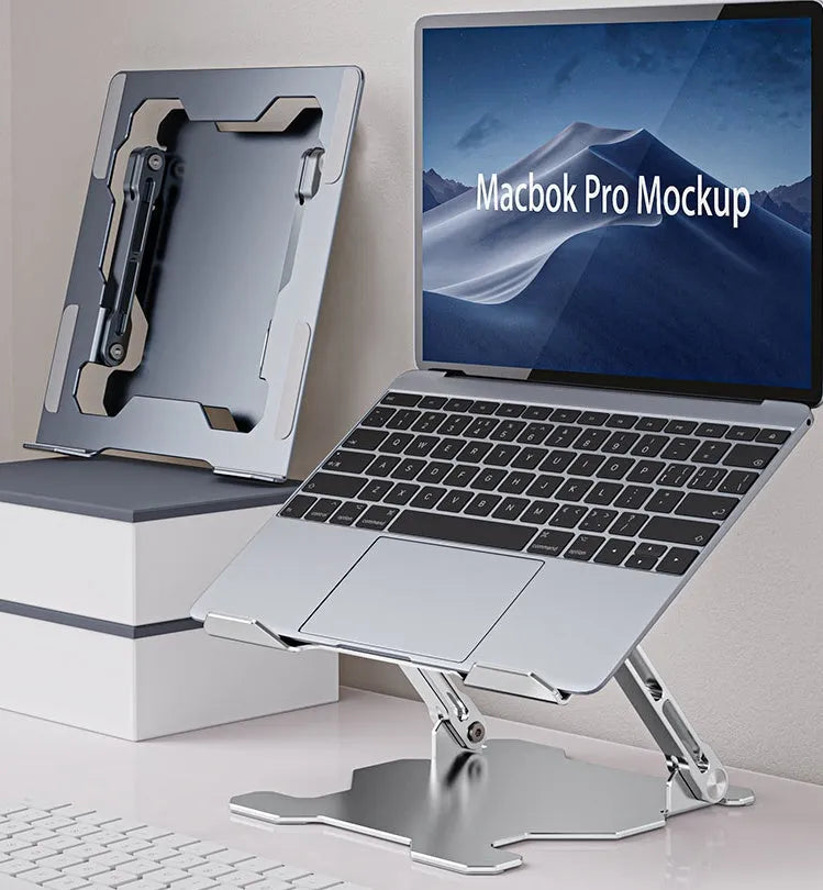 Grey portable aluminum laptop stand shown folded and in use with a silver laptop, demonstrating its adjustable angle.