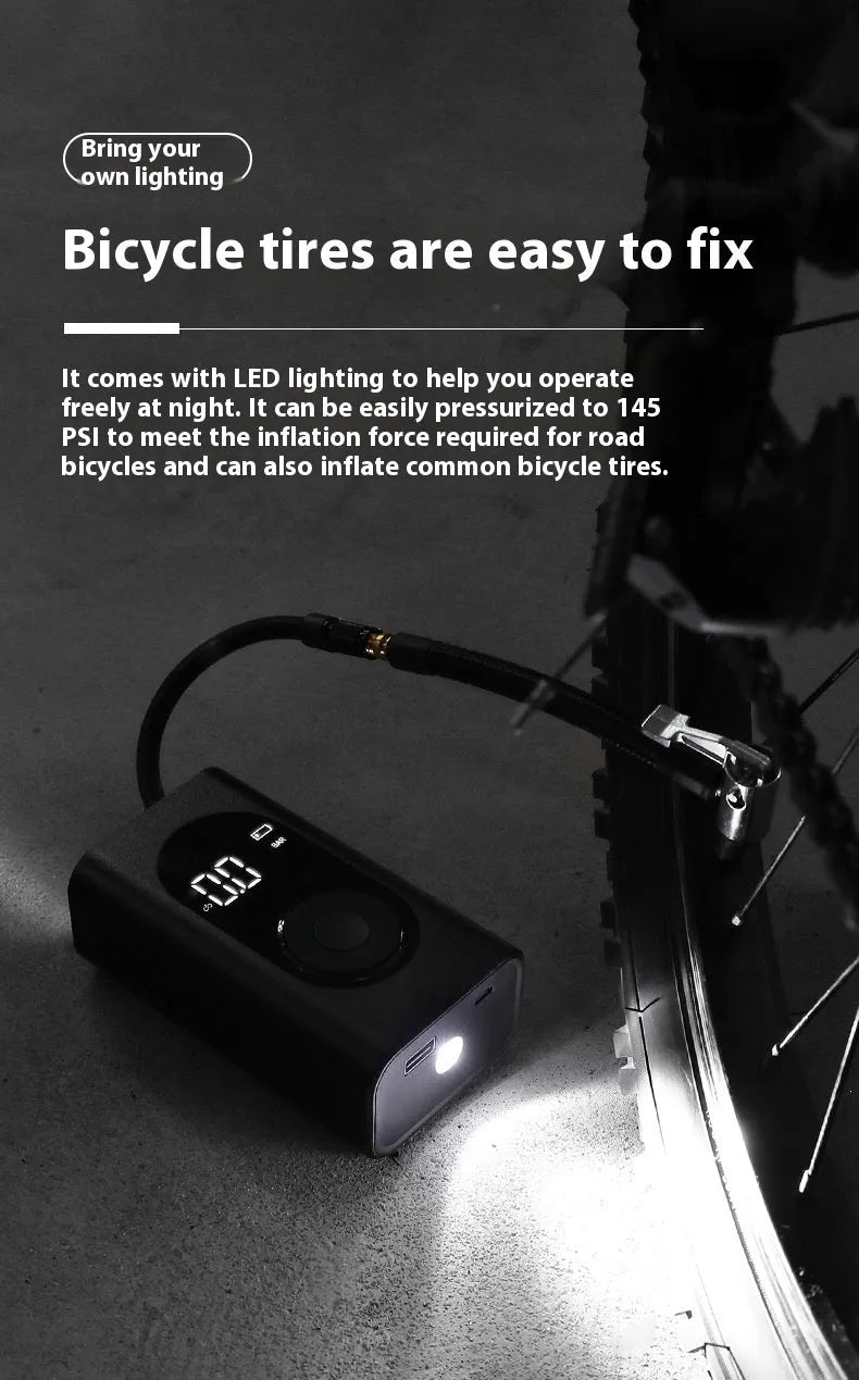 Compact black handheld wireless tyre inflator with digital display, attached air hose, and USB cable.