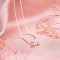 Silver cherry necklace for women with adjustable snake bone chain on a white background.