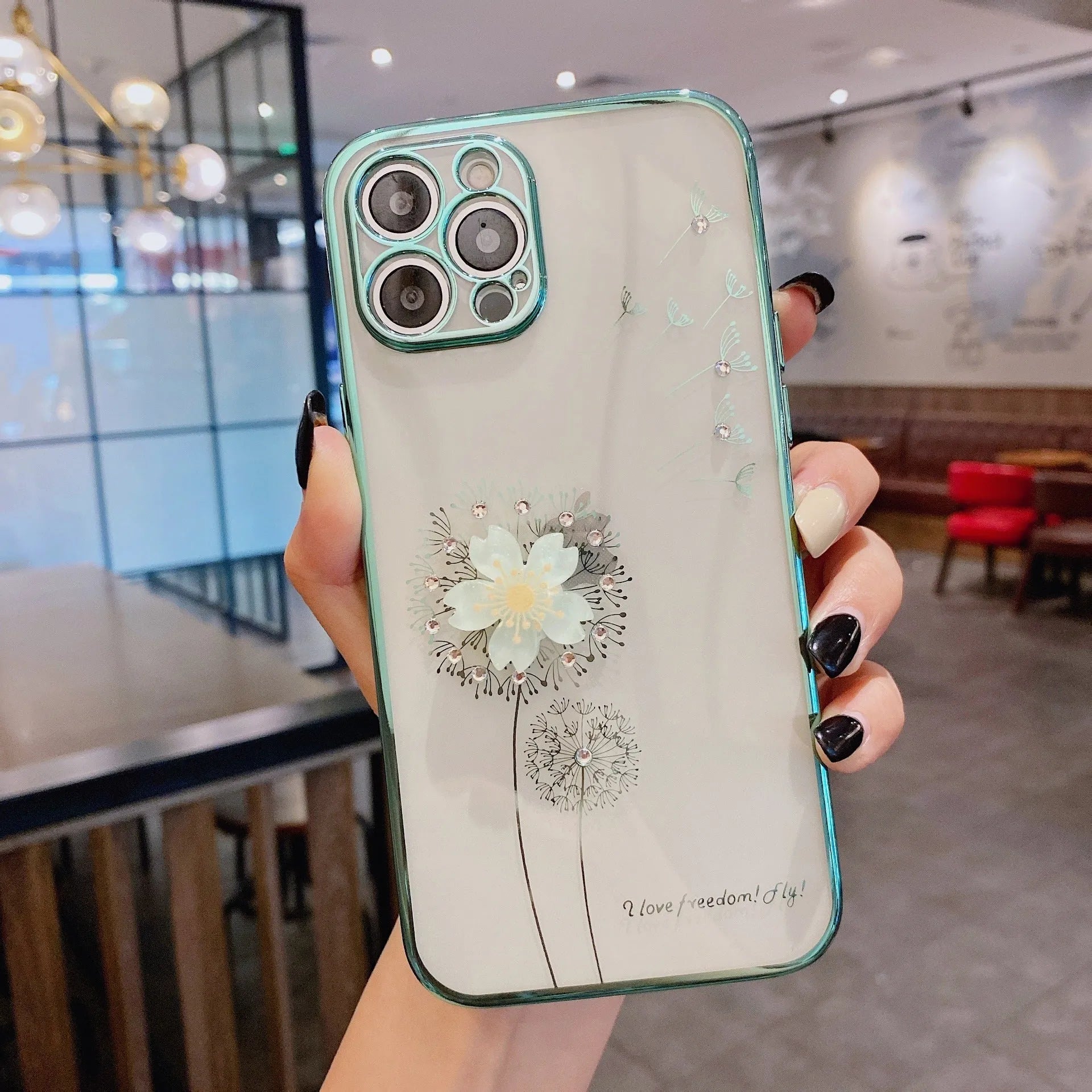 Green iPhone case with a spinning 3D white floral decoration and built-in screen protector.