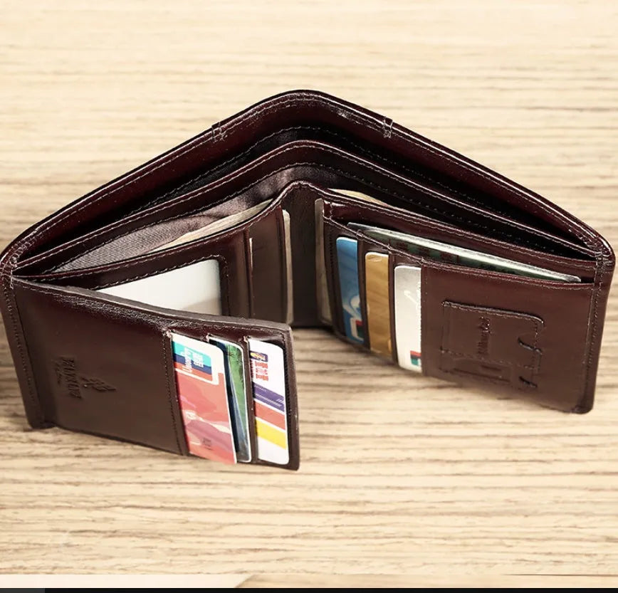 Men's black leather bifold wallet open to show card slots, coin pocket, and photo window.