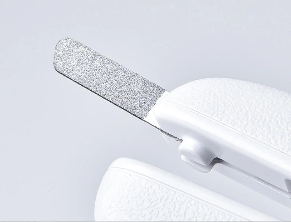 White LED pet nail clippers for cats and dogs with open transparent safety guard and nail file.