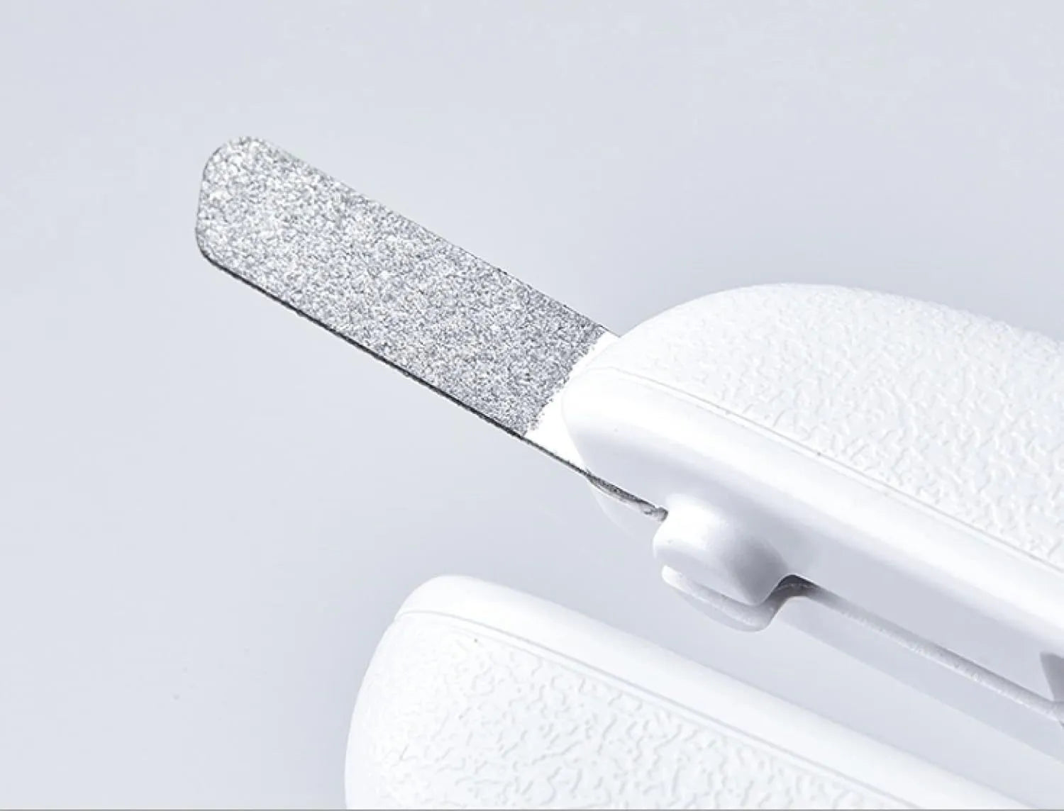White LED pet nail clippers for cats and dogs with open transparent safety guard and nail file.
