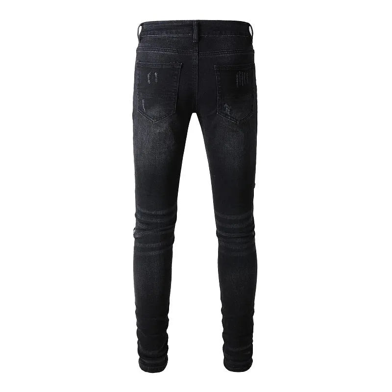 Men's black denim jeans with tattered hem and simple print patch detail