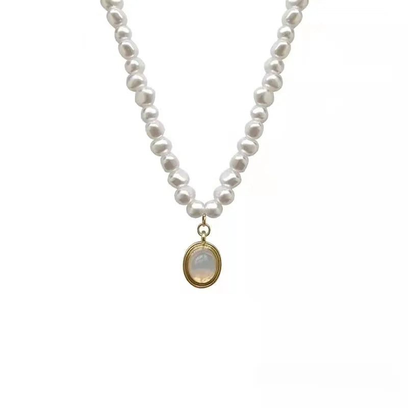 Adjustable geometric alloy pendant necklace with electroplated finish on a grey background.