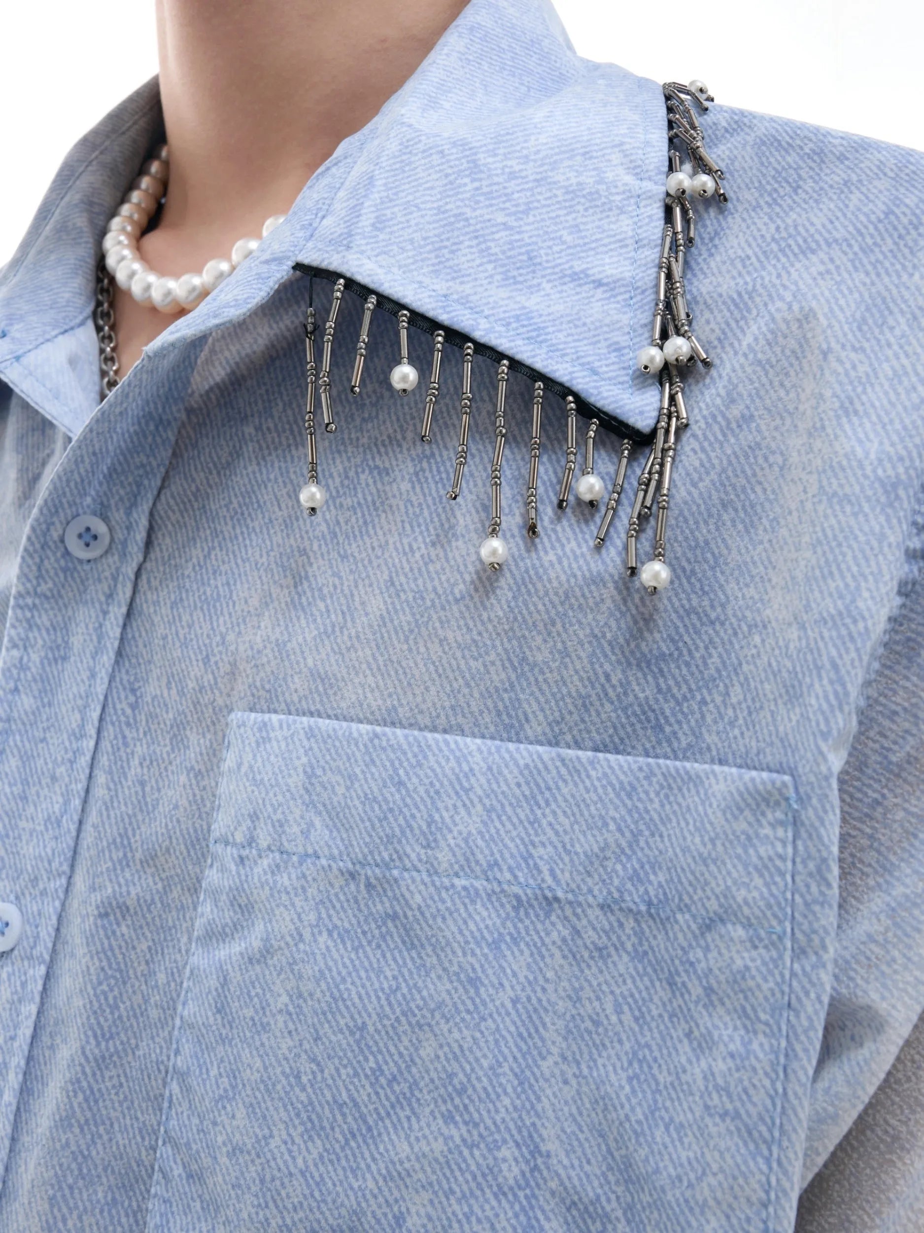 Blue and white gradient short-sleeved loose fit shirt on a hanger.