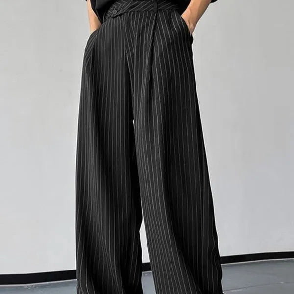Men's black vertical striped pleated casual trousers showing elasticated waist and leg detail