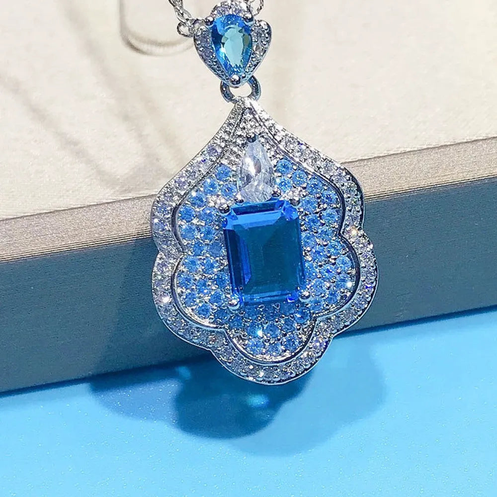 Sea blue geometric copper pendant charm with aquamarine topaz design, shown without a chain.