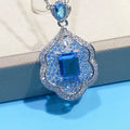 Sea blue geometric copper pendant charm with aquamarine topaz design, shown without a chain.