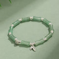 Green aventurine bamboo strawberry quartz crystal bracelet with mixed natural stones on wrist