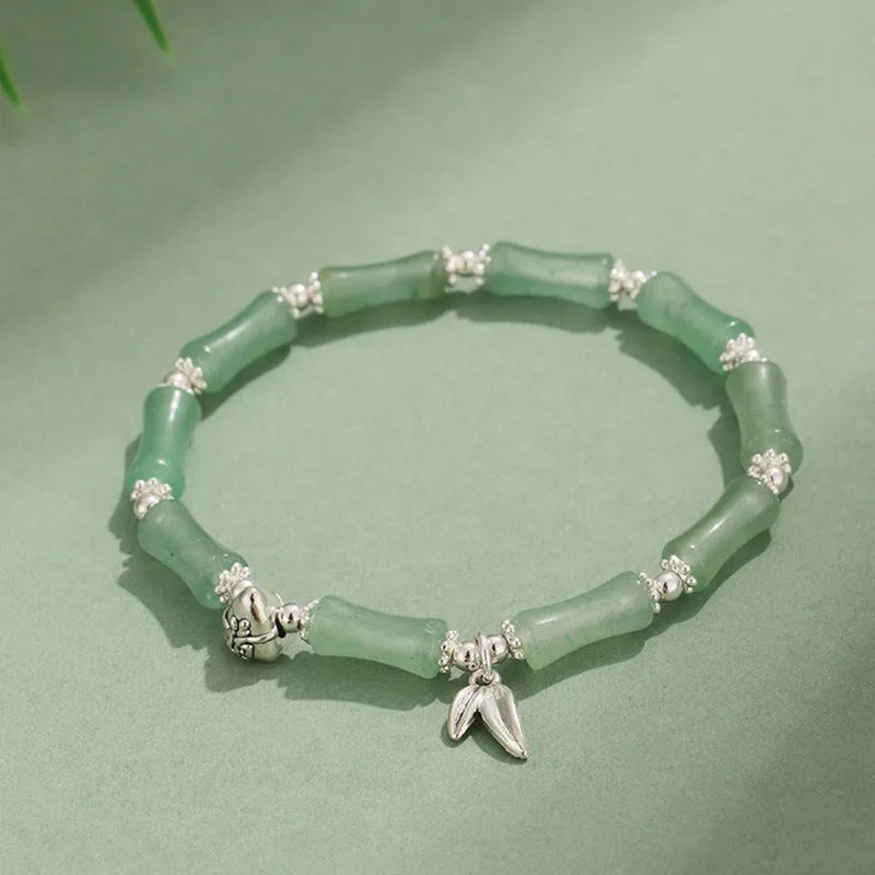 Green aventurine bamboo strawberry quartz crystal bracelet with mixed natural stones on wrist