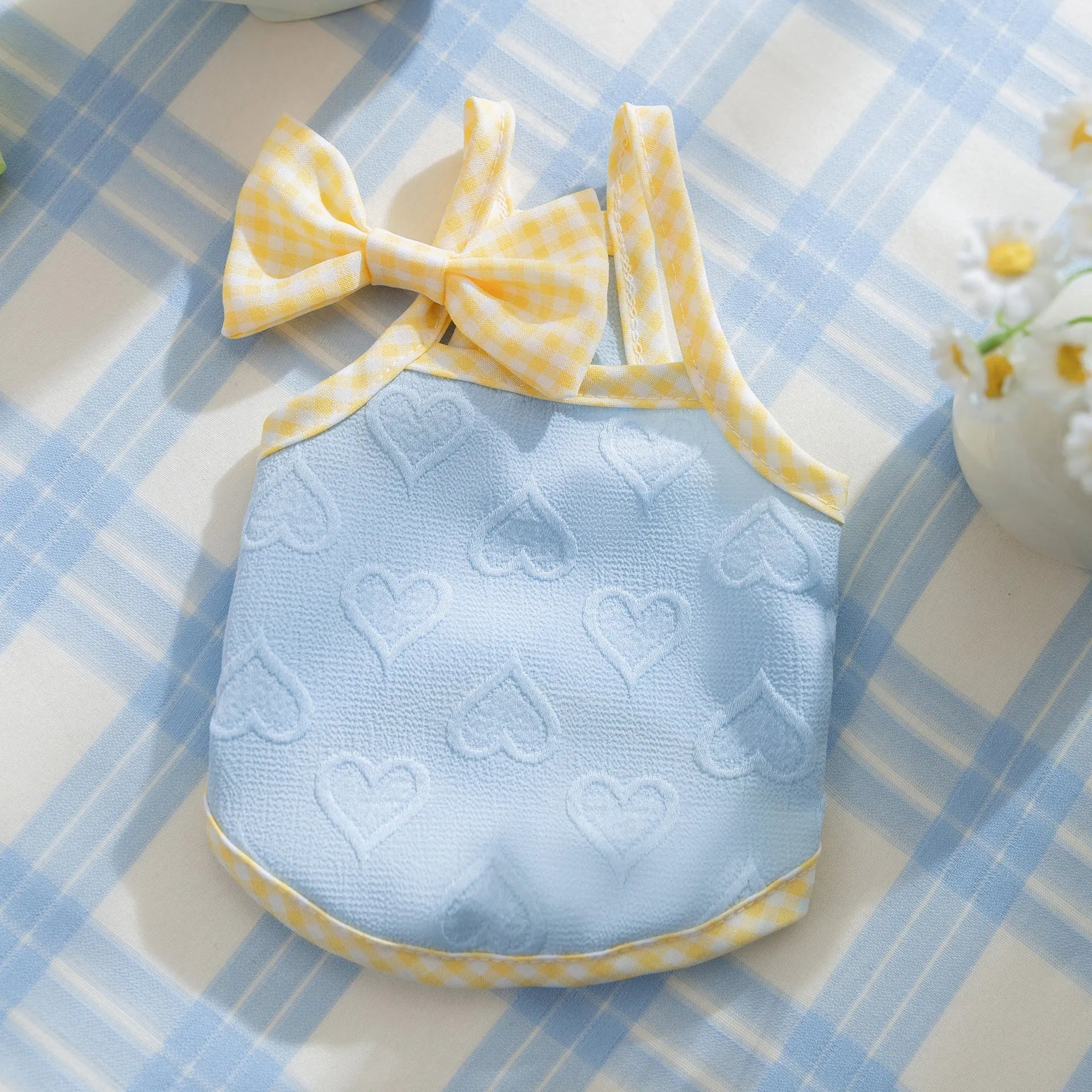 Small dog wearing heart texture bow suspenders vest in Bondi Blue colour