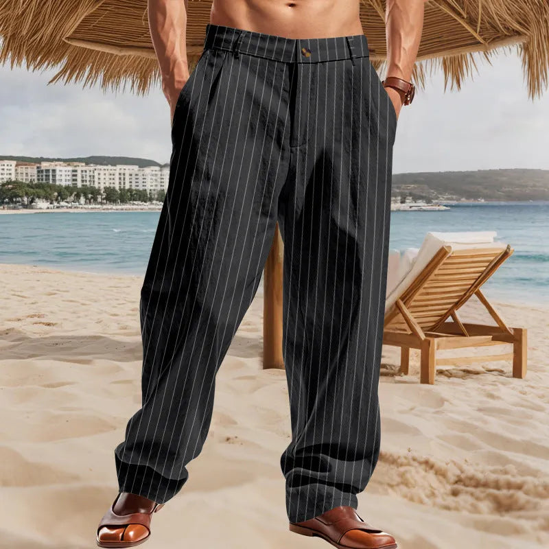 Man wearing beige striped linen trousers with a high waist and wide loose legs.