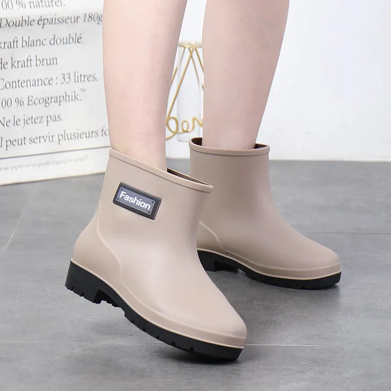 Women's black mid-calf rain boot made of PVC with a low heel.