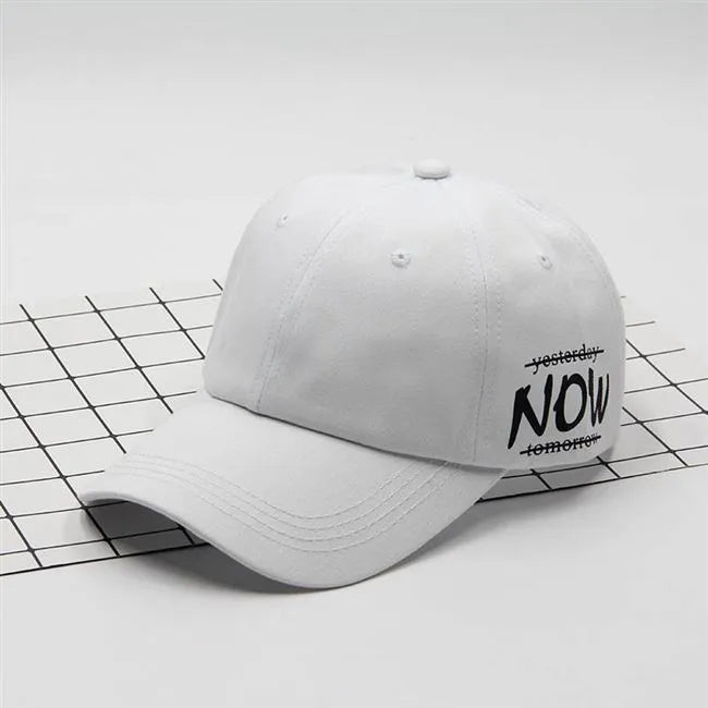 Cotton baseball cap with letter embroidery, adjustable back, curved brim, in beige on white background