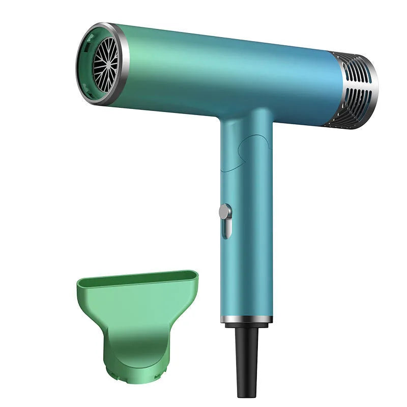 Green foldable hair dryer with collapsed handle next to a suitcase, demonstrating its travel-friendly portable design.