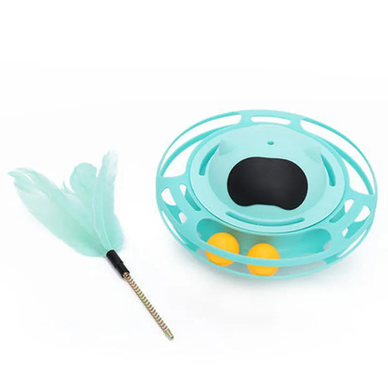 Pink cat tumbler turntable toy with a colourful baton on a flat surface.