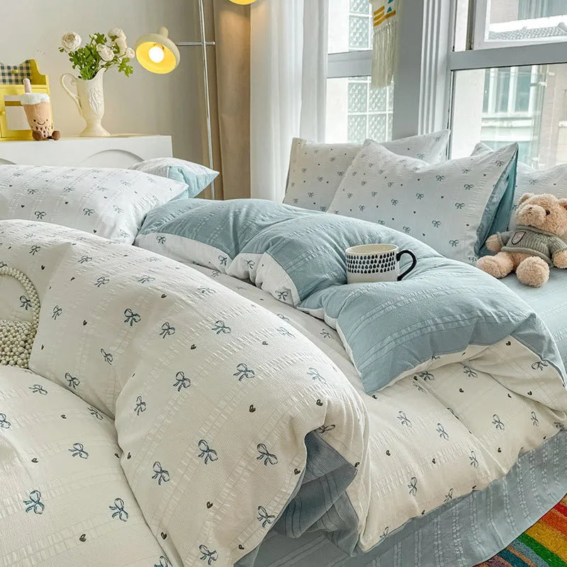 Aerobic jacquard cloud yarn four-piece bedding set with quilt cover, sheet, and pillowcases in a soft pattern.