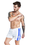 Man modelling blue casual sports shorts with lace-up front and slim fit.