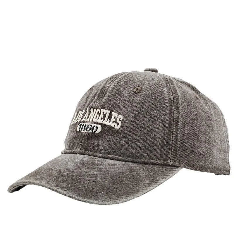 Retro personalised washed distressed embroidered peaked cap in beige with adjustable snapback.
