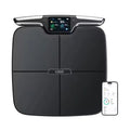Black eight-electrode body fat weighing scale on a hard floor