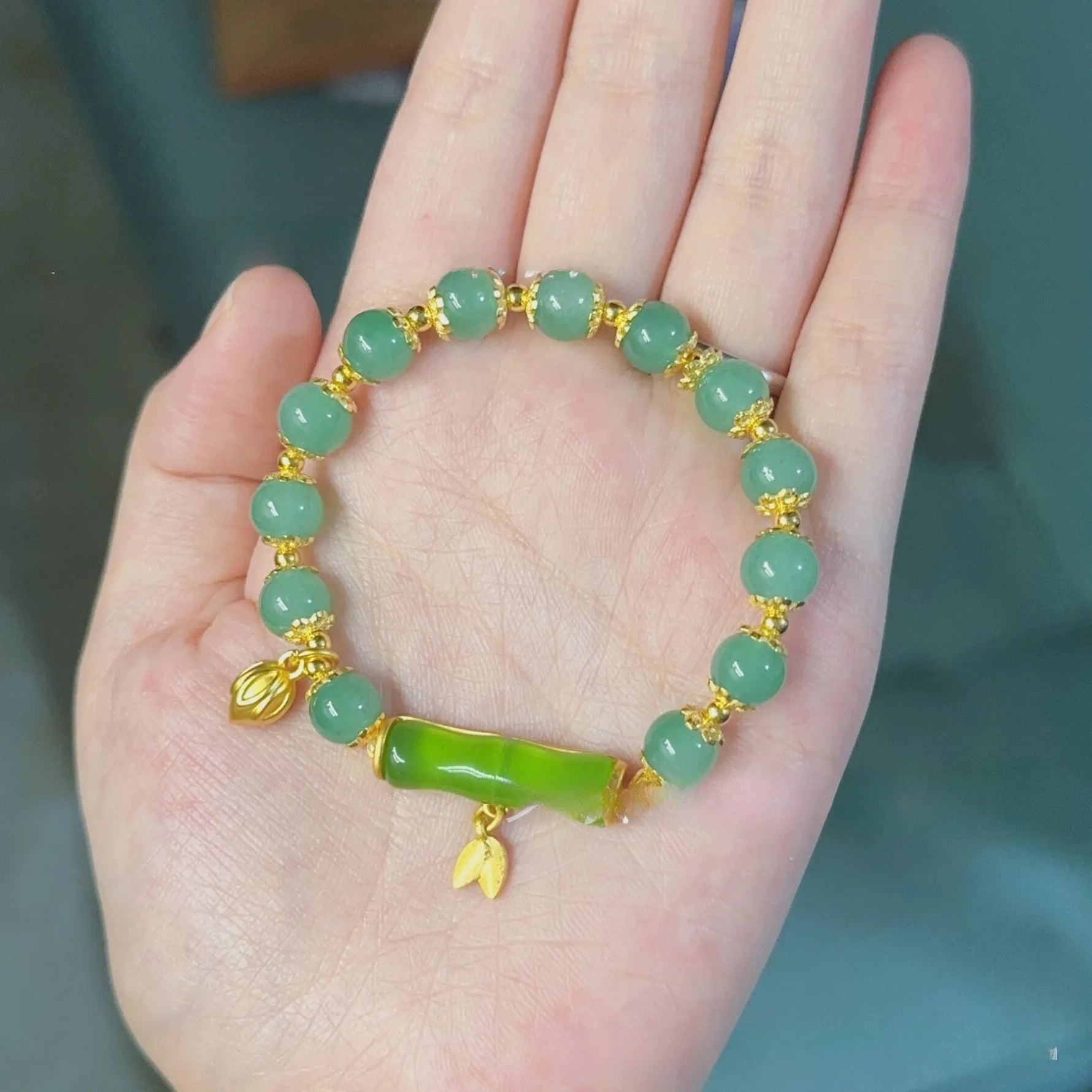 Bamboo style bracelet with electroplated coloured glass beads in a Ruyi flower design.
