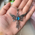 Close-up of a colourful alloy necklace featuring a geometric pendant with devil wings and a cross design.
