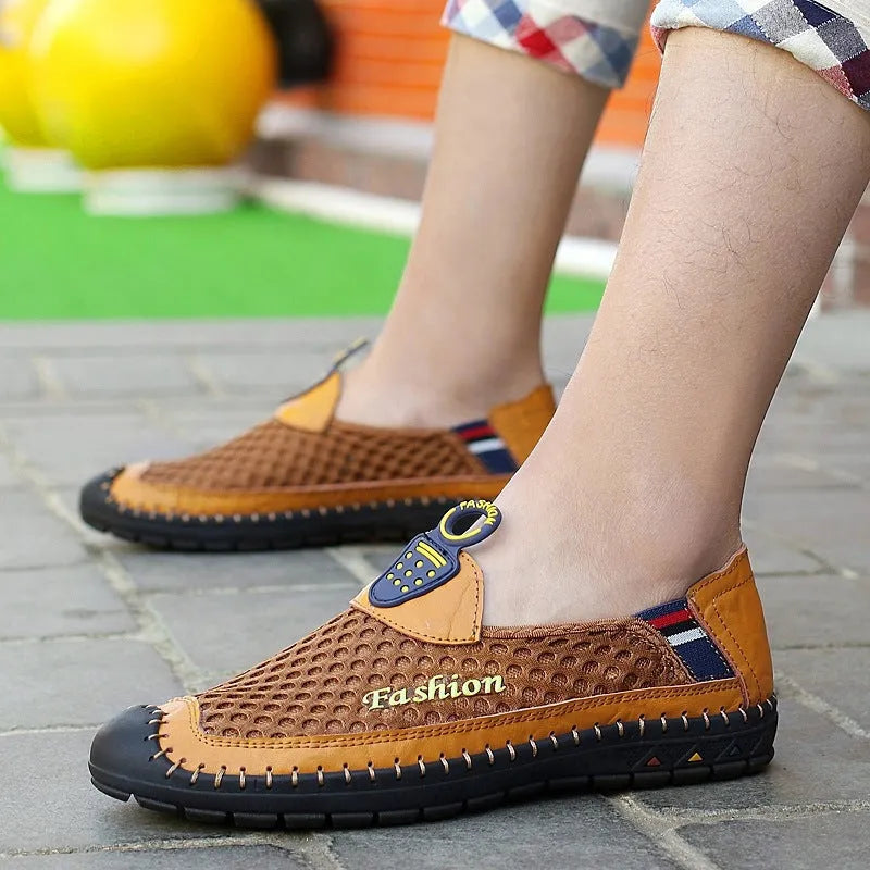 Men's brown casual shoes with mesh upper and rubber sole on a light background.