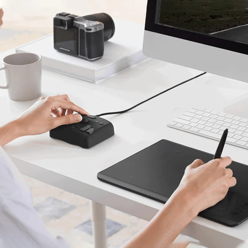 TourBox NEO black auxiliary keyboard for video editing on a desk