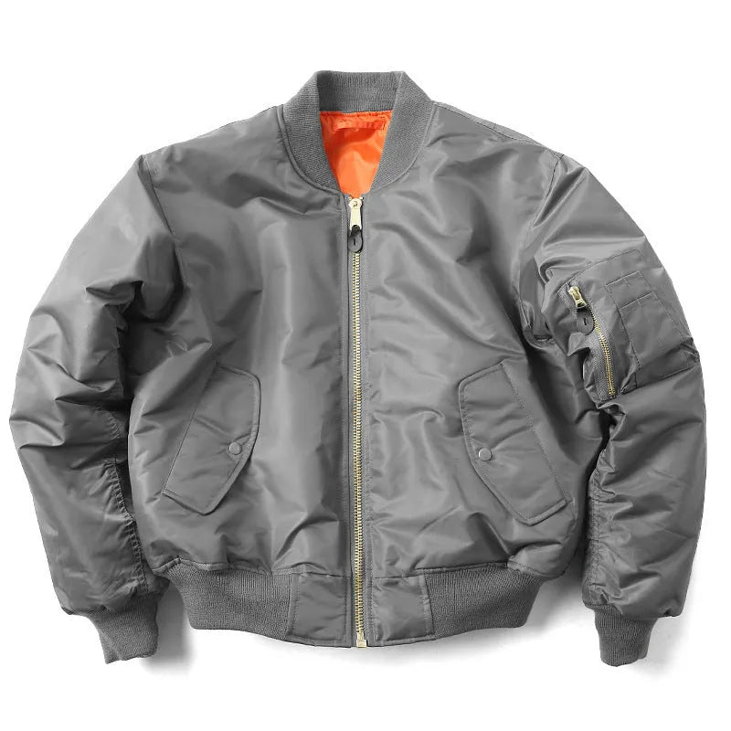 Man wearing a reversible army green nylon pilot jacket, showing the double-sided workwear design.