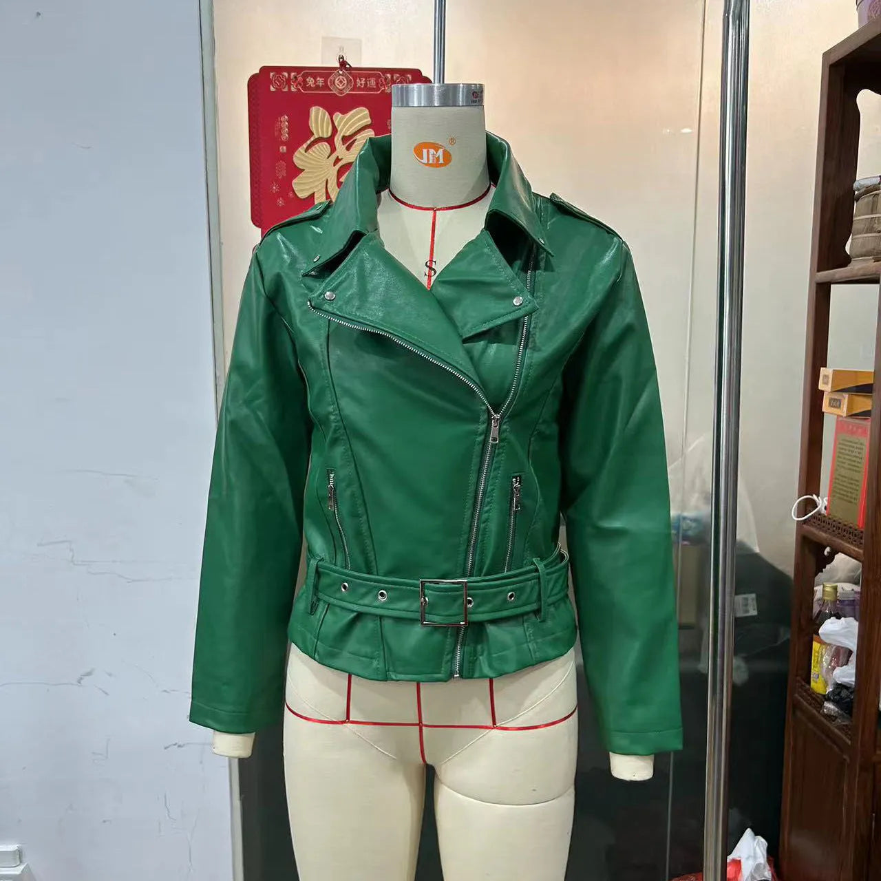 Punk style short jacket with a Peter Pan collar on a hanger, showing the drawstring waist.