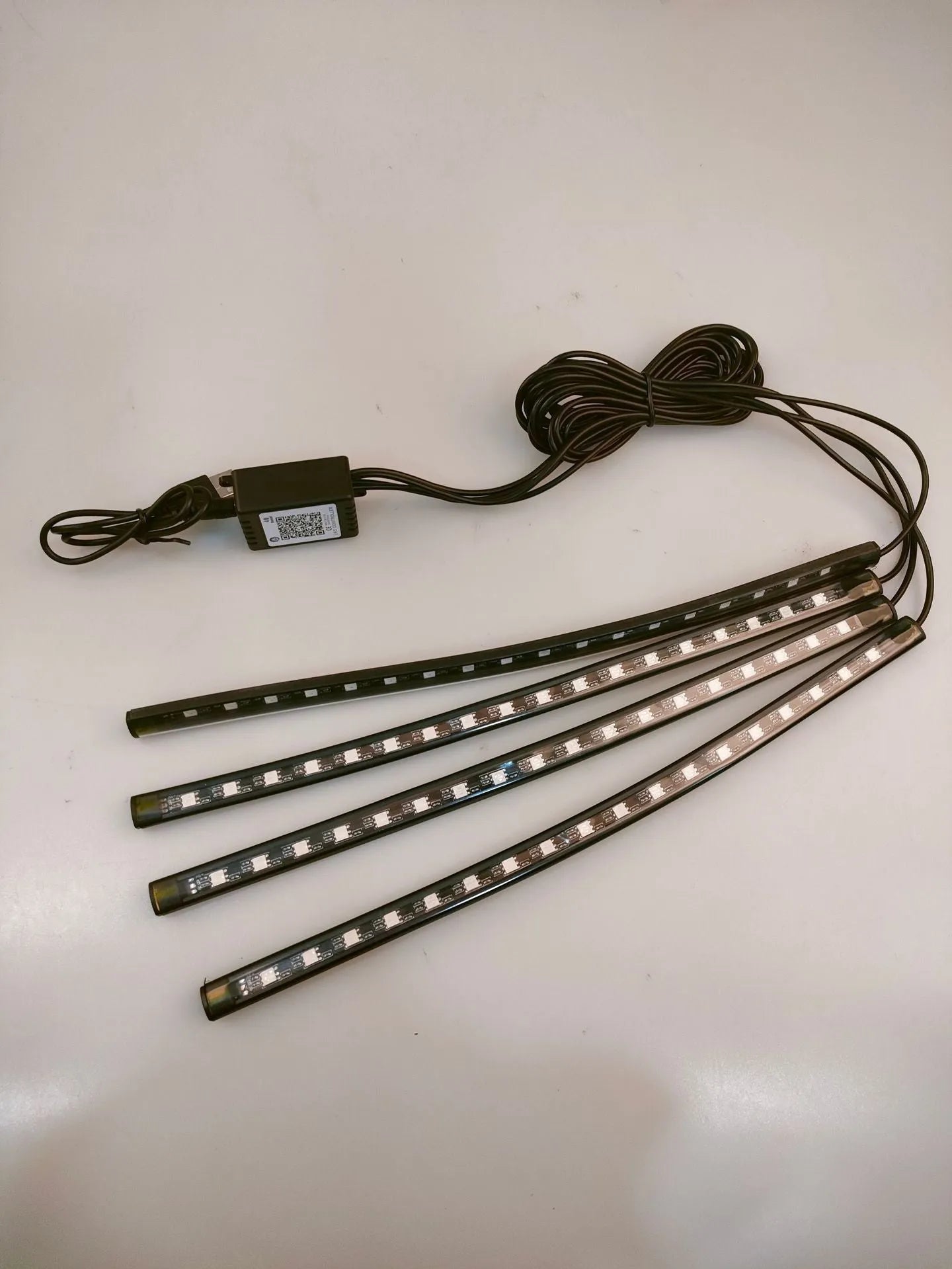 Car interior footwell LED accent lighting kit with four light strips and voice control unit