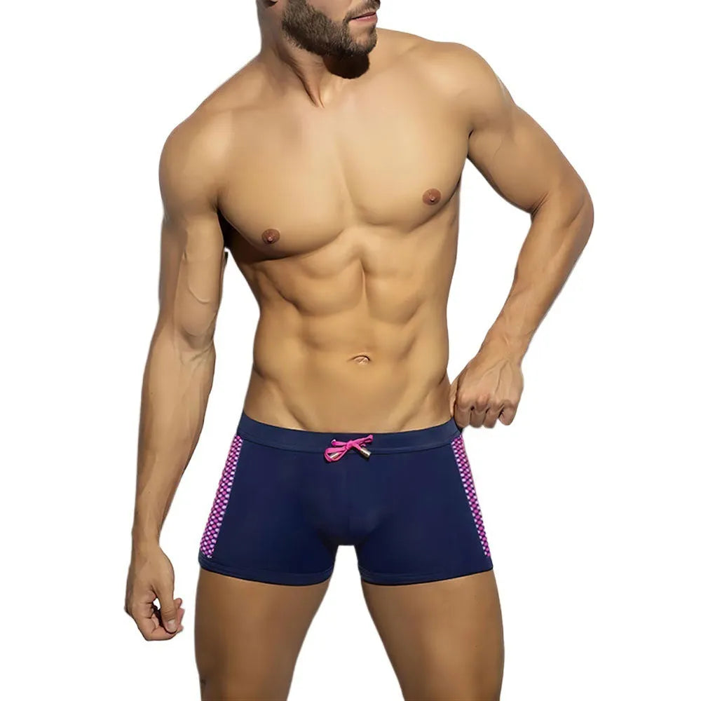 Yellow polka dot print men's swimming boxers on a mannequin, showing brief style.
